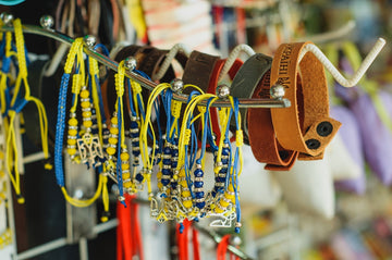 a bunch of bracelets are hanging on a rack
